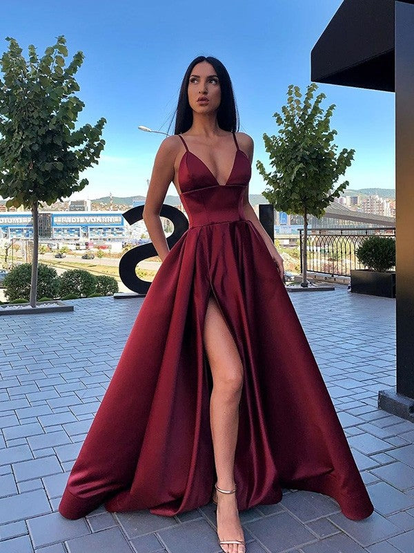 Elegante vestido de fiesta largo de satén con escote en V, abertura frontal y bolsillos.