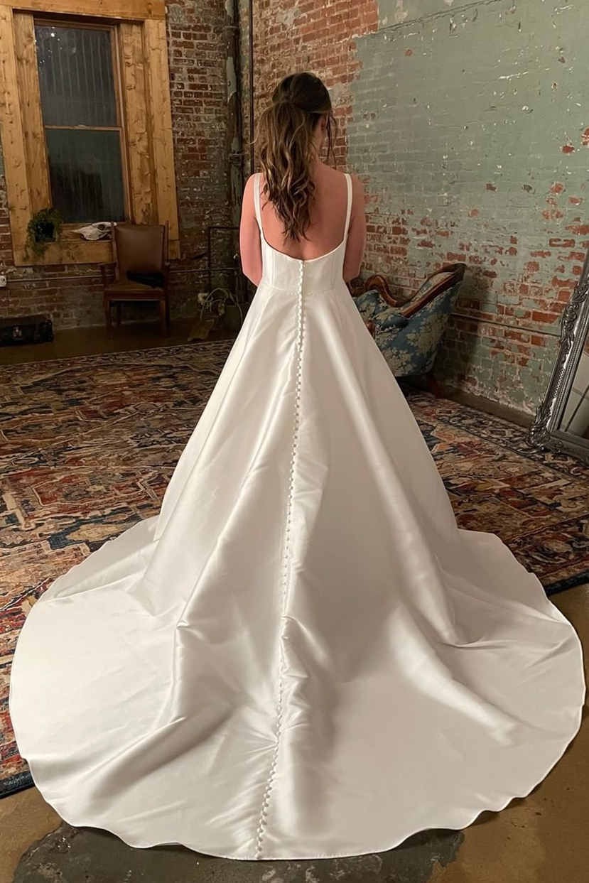 Schlichtes elfenbeinfarbenes Brautkleid mit breiten Trägern und Taschen