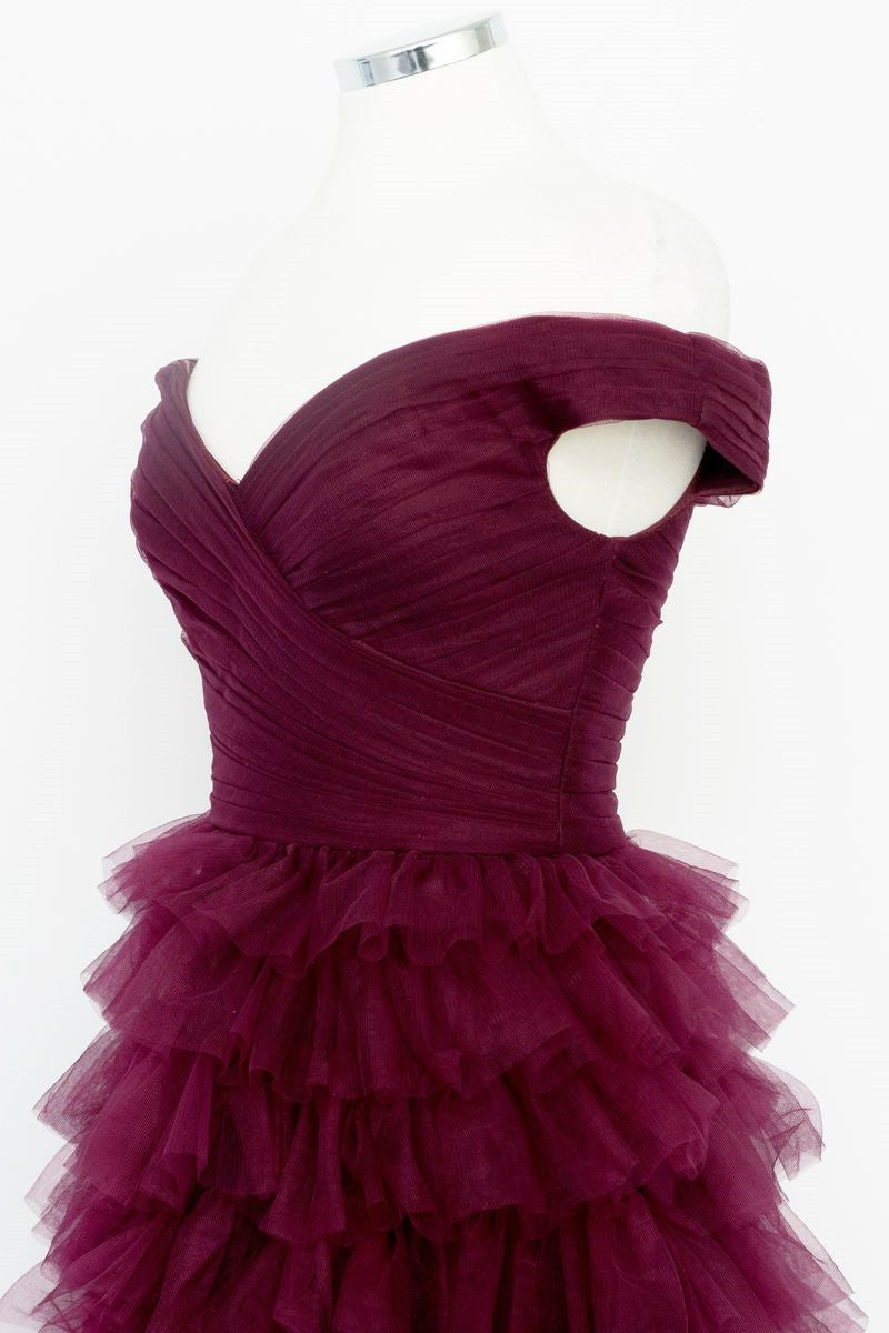 Vestido de fiesta plisado con hombros descubiertos en color baya oscuro, transparente y escalonado