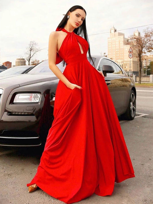 Elegante vestido de fiesta largo rojo con cuello halter y bolsillos.
