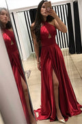 Abito da sera color rosso vino con scollo all'americana, taglio a sirena, spacco e balze