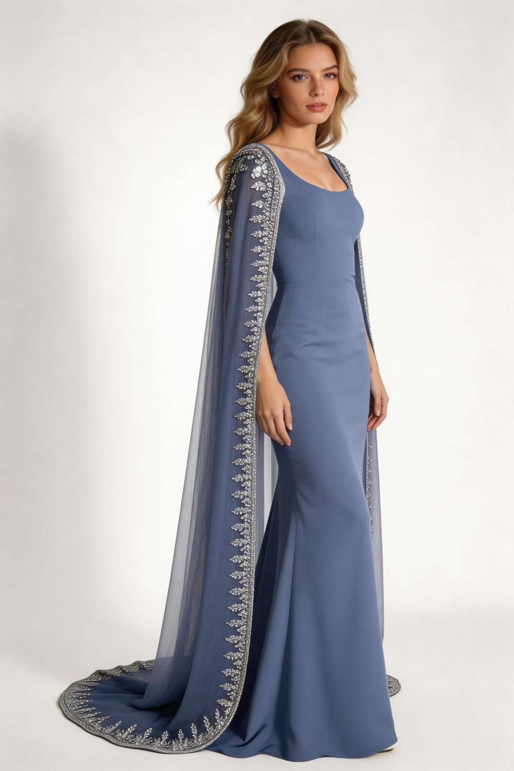 Woman in a blue embroidered evening gown with cape sleeves at ZAPDRESS boutique mirror selfie
