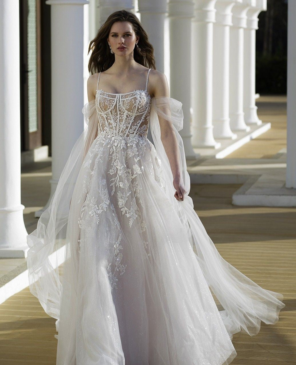 Bellissimi abiti da sposa bianchi con gonna a trapezio in tulle e pizzo, spalline sottili, maniche lunghe e applicazioni