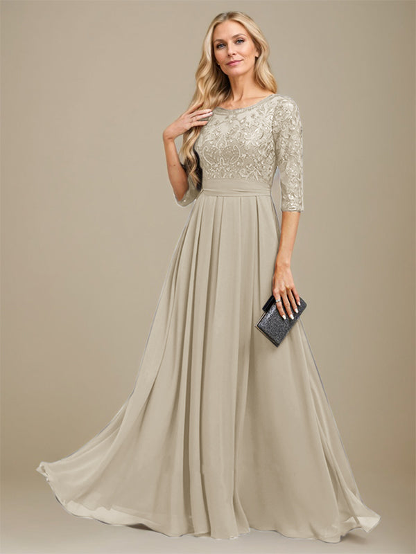 Robe de mère de la mariée en dentelle et mousseline, coupe en A, longueur au sol, décolleté arrondi, ornée d'appliques de paillettes