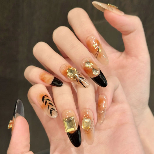Uñas postizas largas francesas con degradado ámbar y lámina dorada para otoño e invierno 