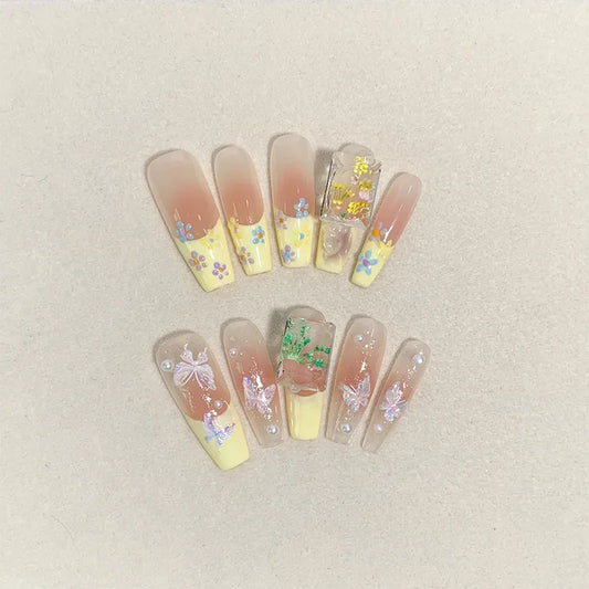 Uñas postizas suaves y extraíbles con diseño de cinta color nude a juego en amarillo tipo escalera larga 