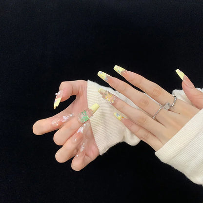Uñas postizas suaves y extraíbles con diseño de cinta color nude a juego en amarillo tipo escalera larga 