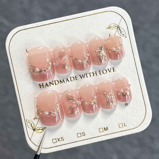10 uñas postizas cortas y redondas, hechas a mano, estilo francés, color rosa, con diseño de ojo de gato y diamantes de imitación de perla. 