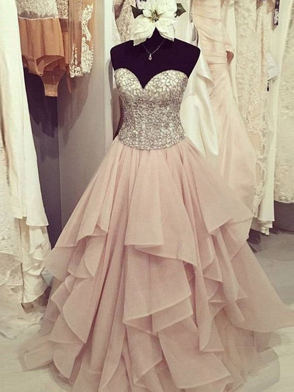 Robe de bal longue jusqu'au sol en mousseline, sans manches, à décolleté cœur, ornée de perles