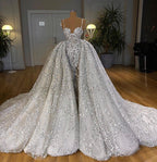 Abito da sposa lungo a sirena con scollo a cuore, paillettes brillanti e strascico con balze