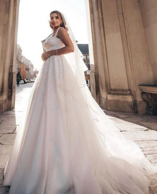 Vestido de novia encantador con tirantes al descubierto y largo hasta el suelo en forma de A