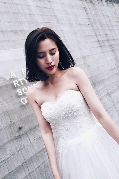 Vestidos de novia de tul con cuentas y escote corazón alto y bajo con cola de corte