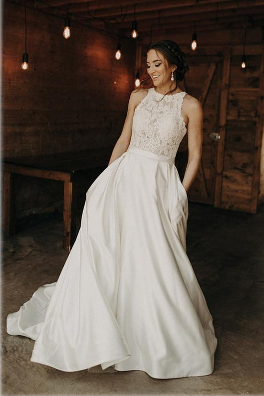 Vestido de novia de corte A con escote halter, ilusión y encaje, y cola larga