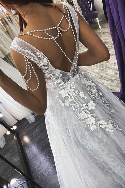 Vestido de novia largo con escote en V, tirantes finos, apliques de perlas y espalda descubierta