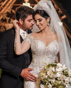 فستان زفاف تول بأكمام طويلة على شكل حورية البحر بدون أكتاف مزين بتطريزات الدانتيل